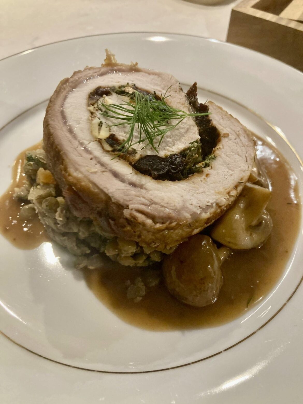 Braised Pork Loin — prunes, almonds, dill; lentils with mirepoix and potatoes; white stock reduction with mushrooms & currant