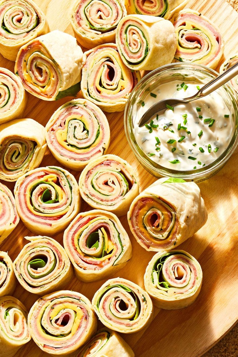 picnic sandwich pinwheels on a wood cutting board