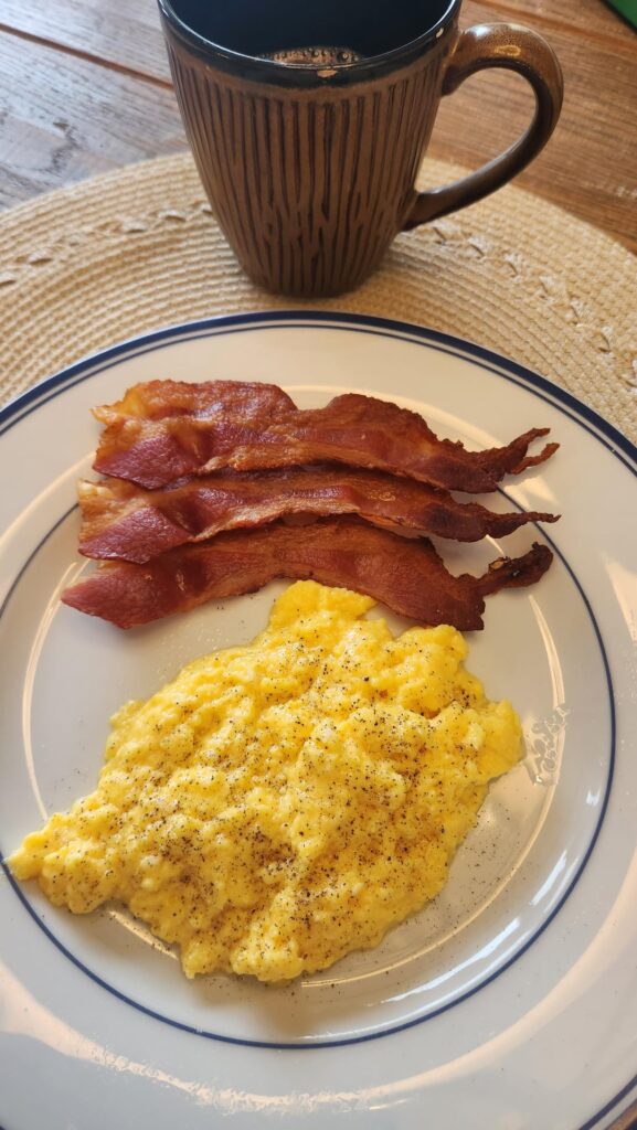 Soft scrambled eggs with crispy bacon