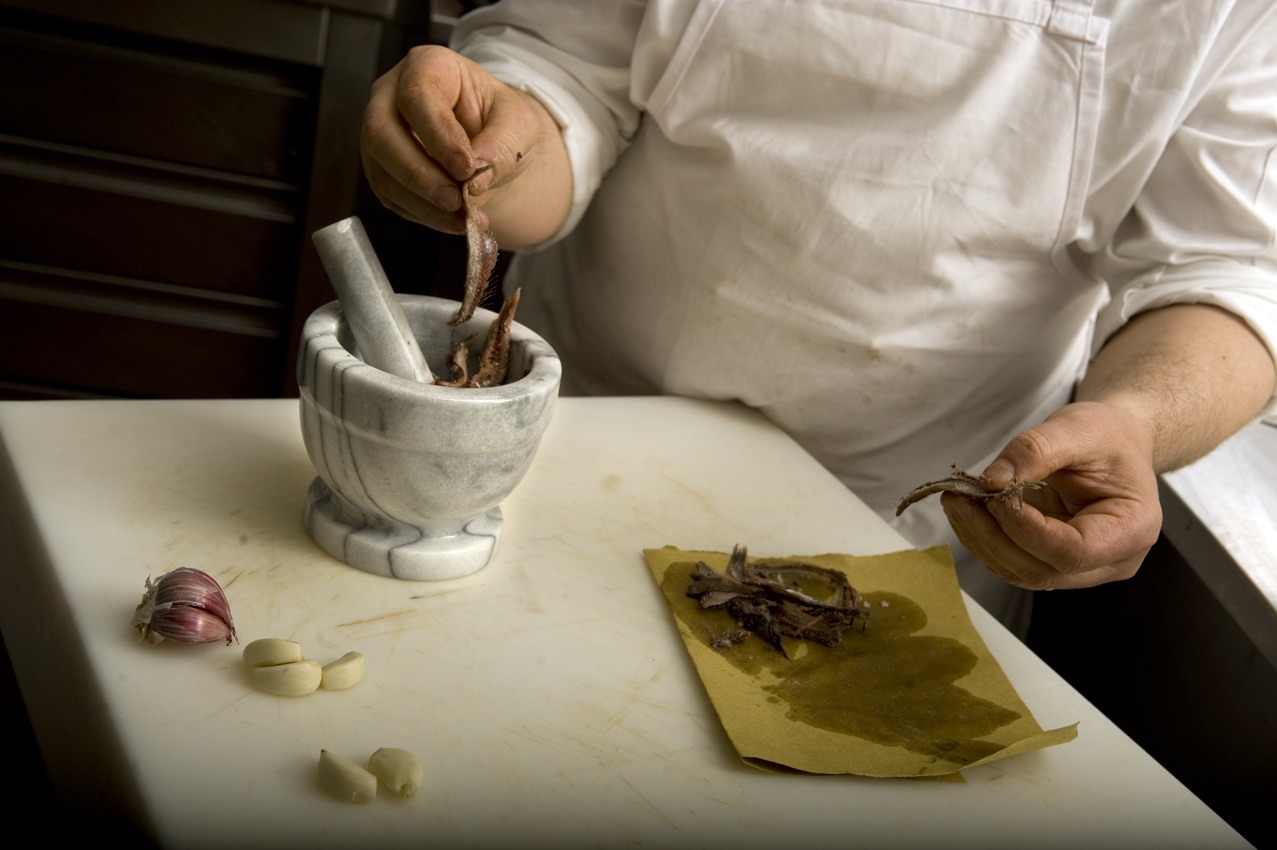Preparing a chicory and anchovy salad