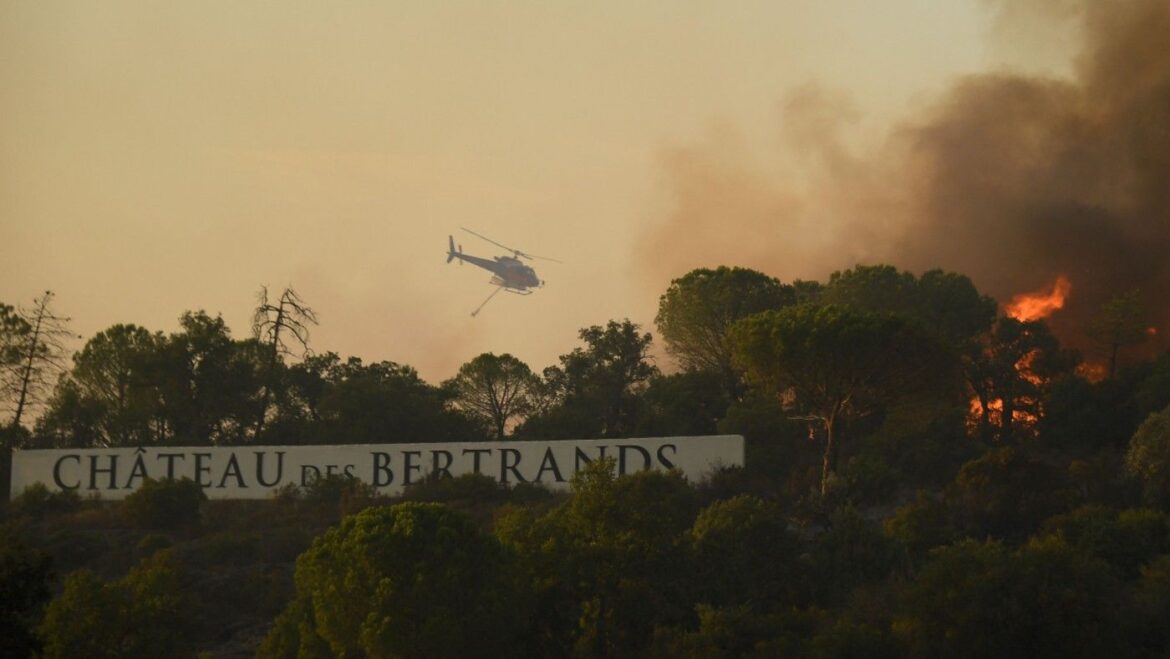 A firefighting helicopter flies above a wildfire near the Ch&acirc;teau des Bertrands winery in the Var region of Provence, France&nbsp;
