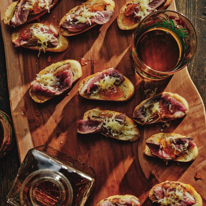 RUM-SEARED DUCK APPETIZER 
Sweet mango chutney and duck come together over crispy bread for a bite-size snack.
Get the recipe