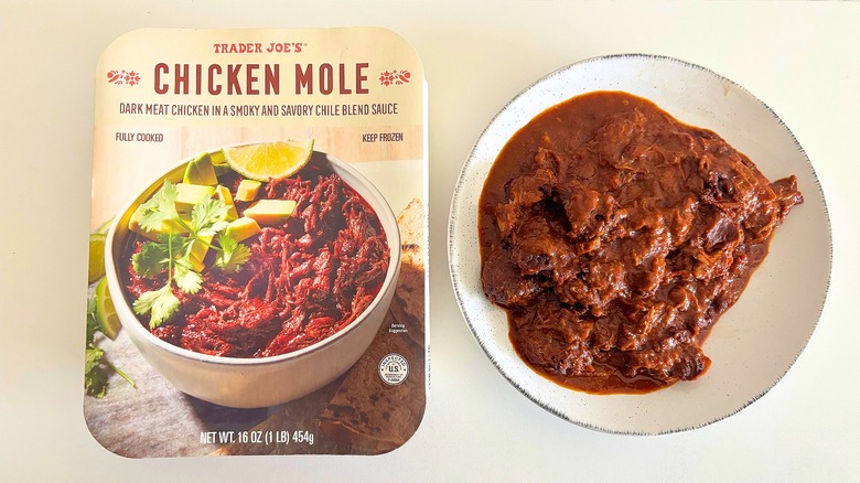 Trader Joe's Chicken Mole in a white bowl next to packaging on a white table