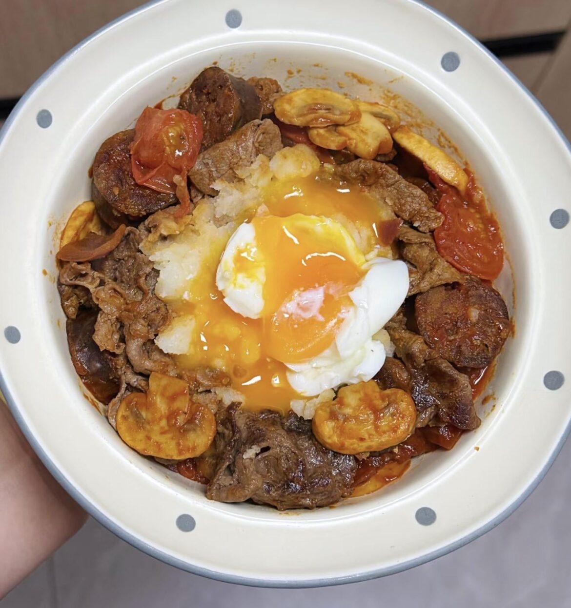 Shakshouka with beef and mashed potatoes over rice
