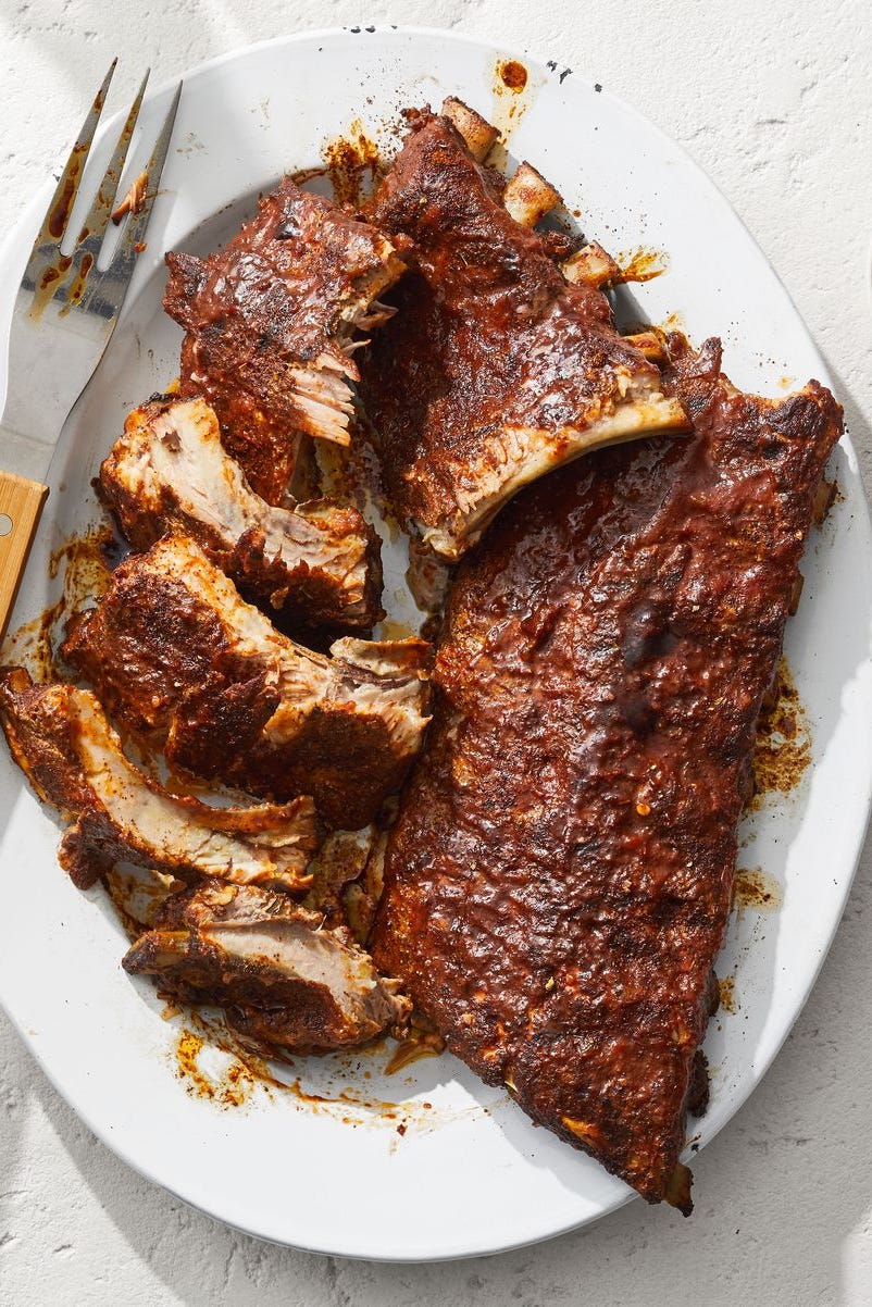 barbecue ribs with bbq sauce on a white plate