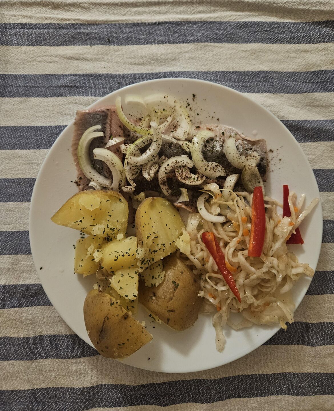 Herrings with onions, potatoes and cabbage salad