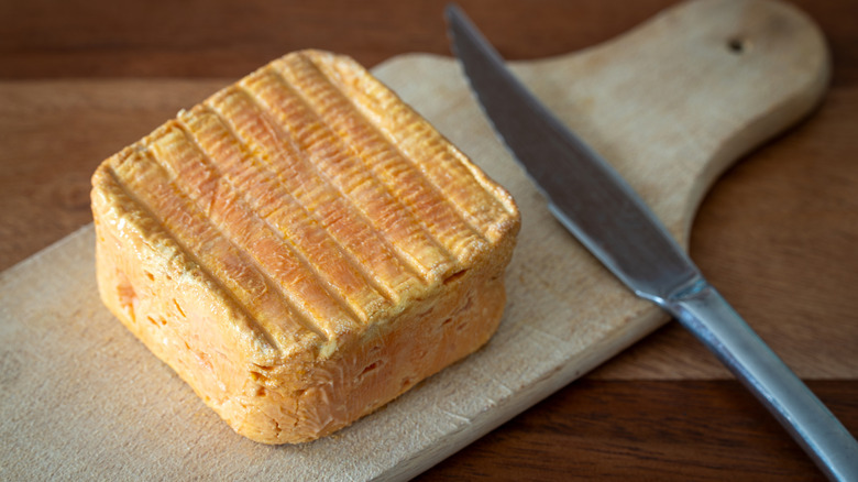 Vieux-Boulogne on a wooden board next to a butter knife
