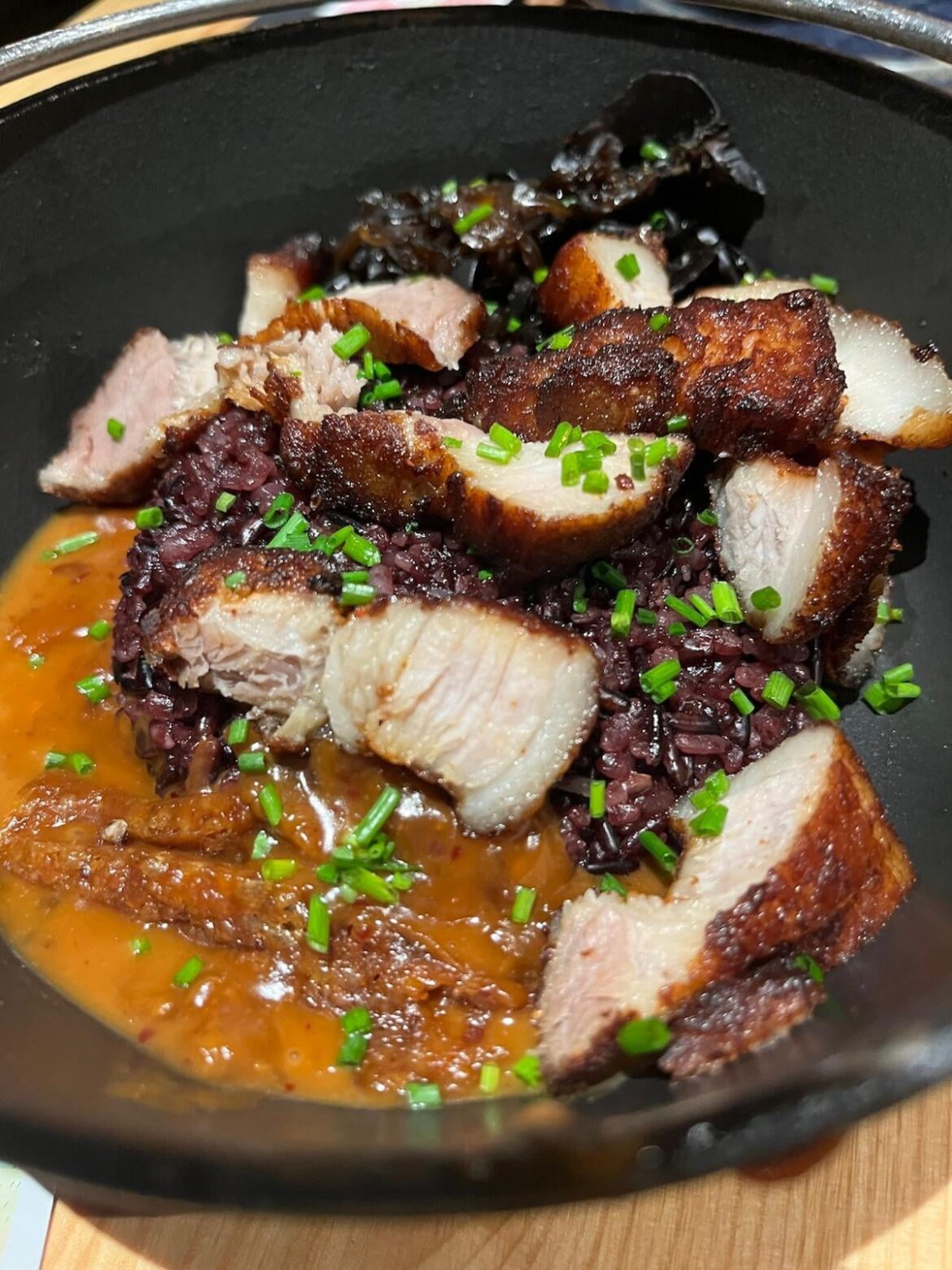 Wild rice bowl with pork belly, chives, peanut sauce and kimch