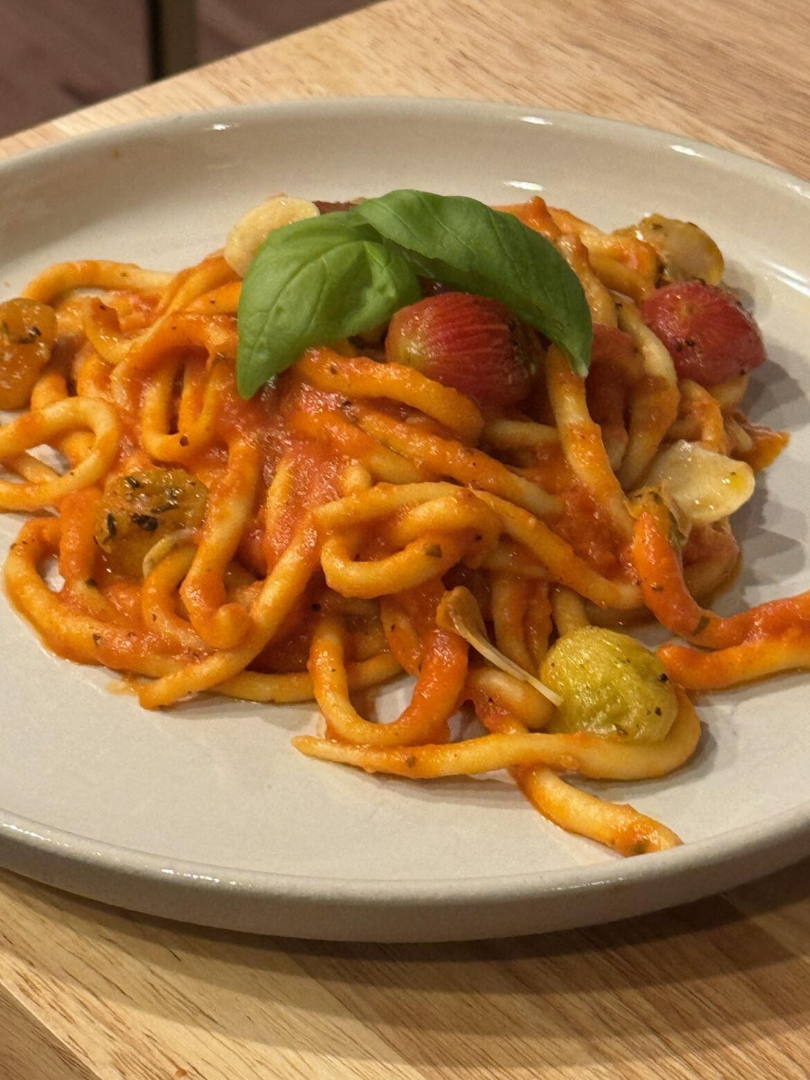 Pici w/ green garlic pomodoro and confit tomatoes