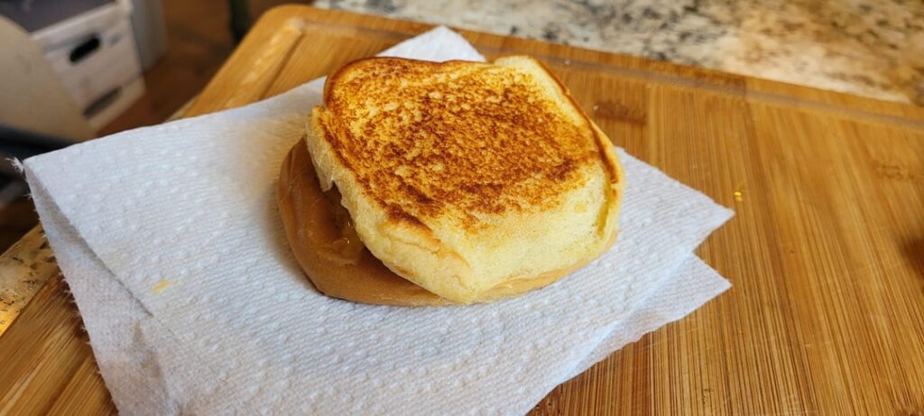 Grilled cheese from the other day. Basic. Inverted Martin's potato bun, one slice of Velveeta singles cheddar. Grilled in BUTTER and NOT mayo.
