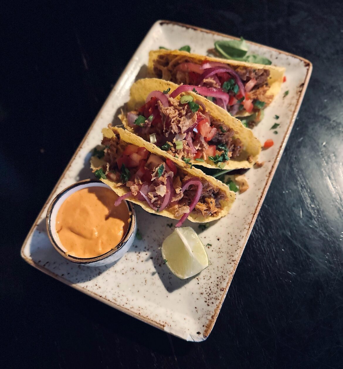 Tacos with pulled pork and sriracha sauce