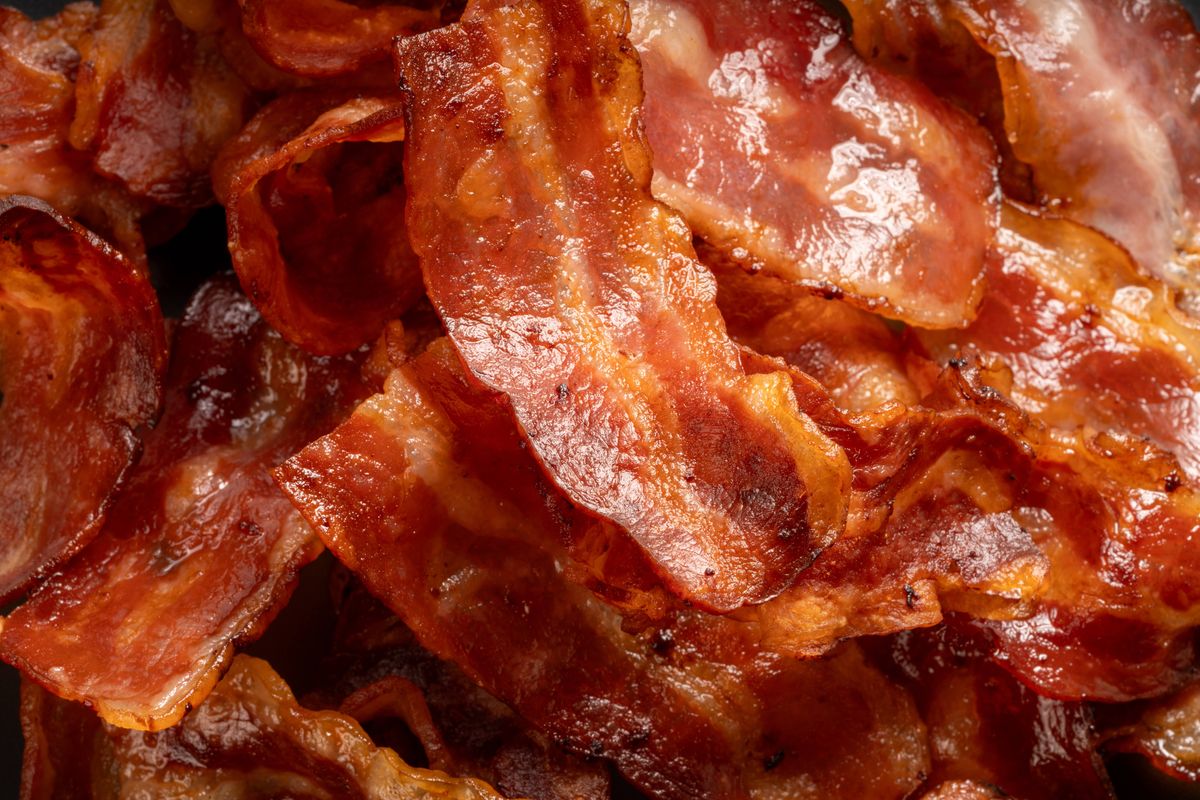 Close up,Crispy fried bacon , freshly cooked and golden brown. Savory breakfast food concept.