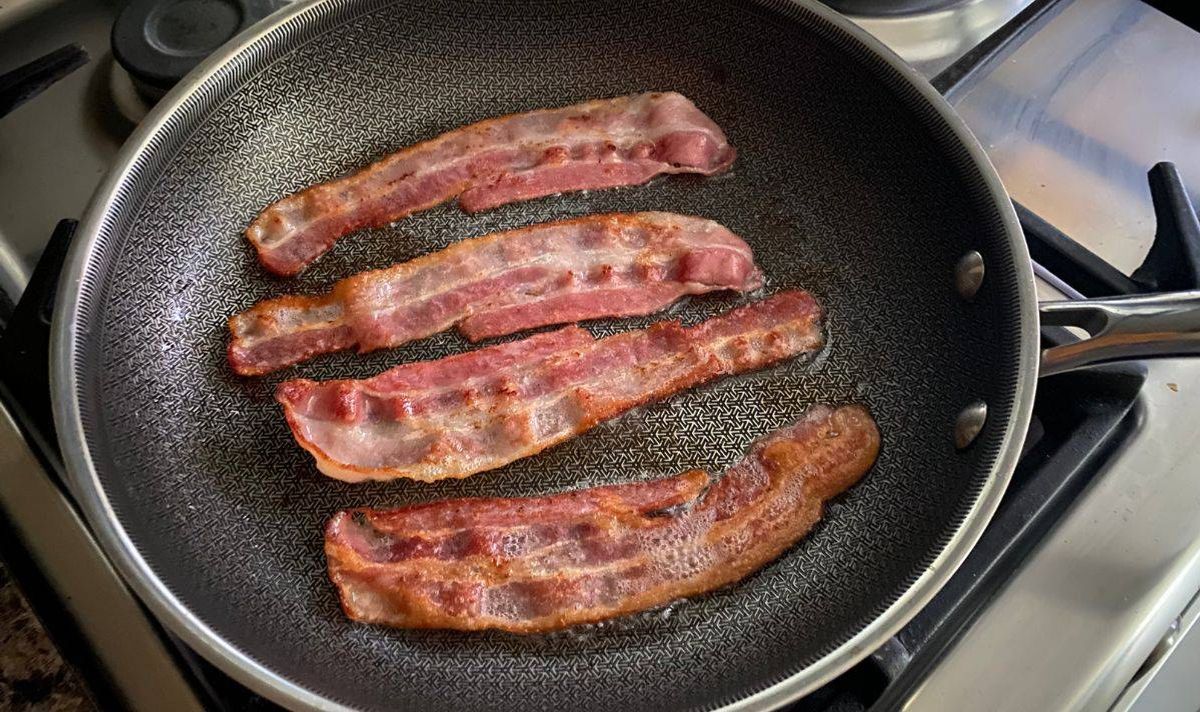 Cooking bacon in frying pan