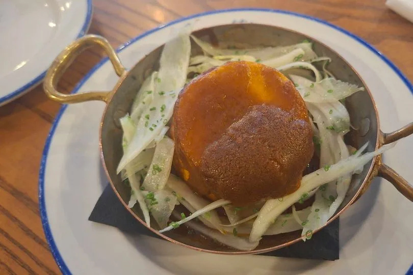 Twice-Baked Crab Soufflé with bisque sauce and fennel salad
