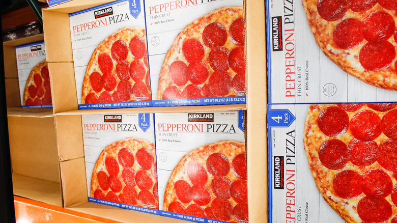 boxes of kirkland pepperoni pizza in cardboard boxes in freezer section at Costco