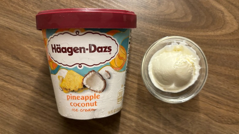 Häagen-Dazs Pineapple Coconut Ice Cream carton next to ice cream in glass ramekin