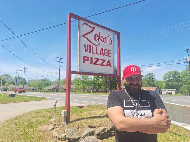 Owner Sam Leo stands at the sign for his Zeko’s Village Italian Restaurant & Pizzeria off N.C 150 in Denver NC on Thursday, April 17, 2025.
