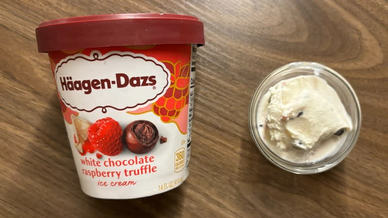 Häagen-Dazs White Chocolate Raspberry Truffle Ice Cream carton next to ice cream in glass ramekin