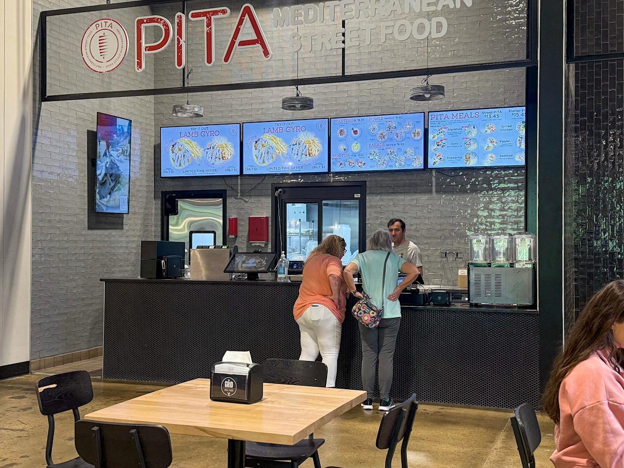 Guests place their order at Pita Mediterranean Street Food restaurant inside The Grid food court area of Wire Park in Watkinsville, Ga., on Tuesday, April 14, 2026.