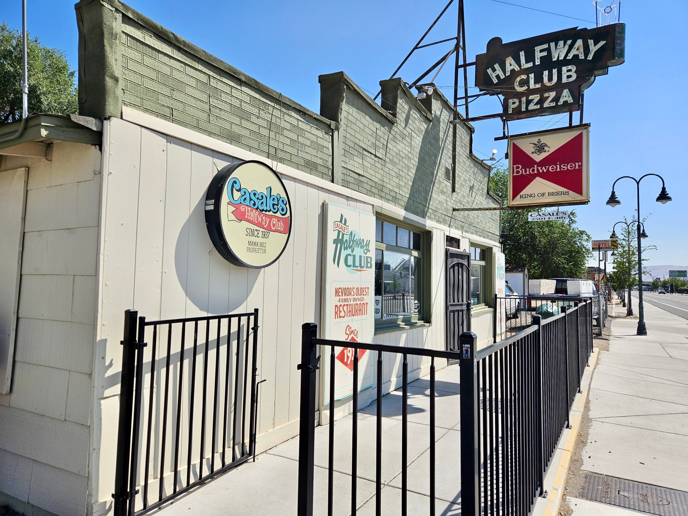 Exterior of Casale’s in Nevada with a gray building and vintage sign.