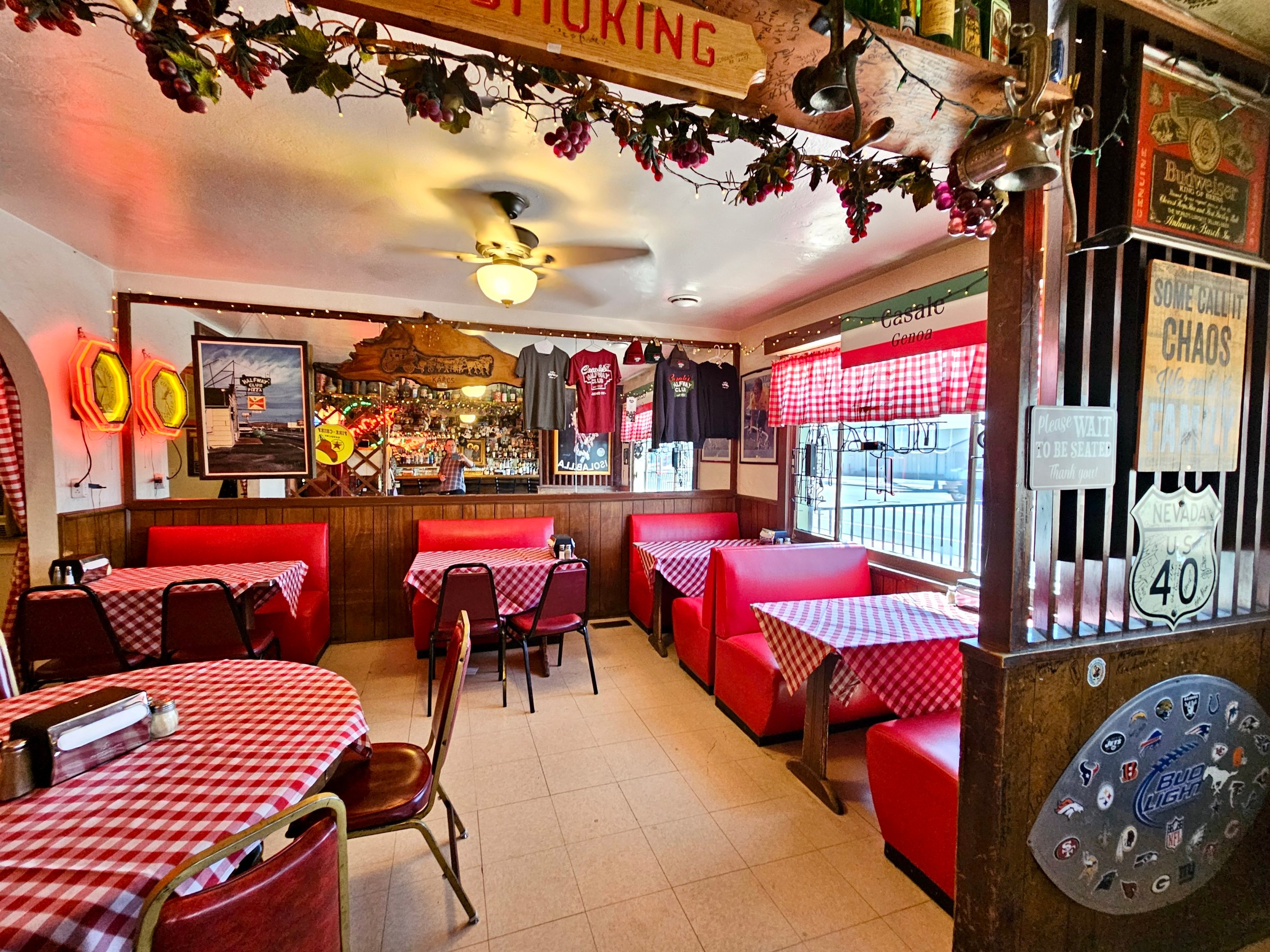 Interior of Casale’s Halfway Club with red booths and tables.
