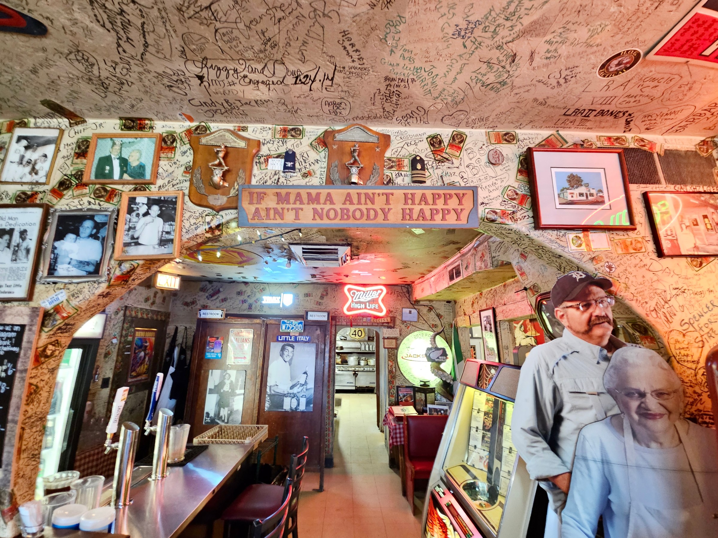 Interior of Casale’s Halfway Club with a sign that reads, “If Mama Ain’t Happy Ain’t Nobody Happy.”
