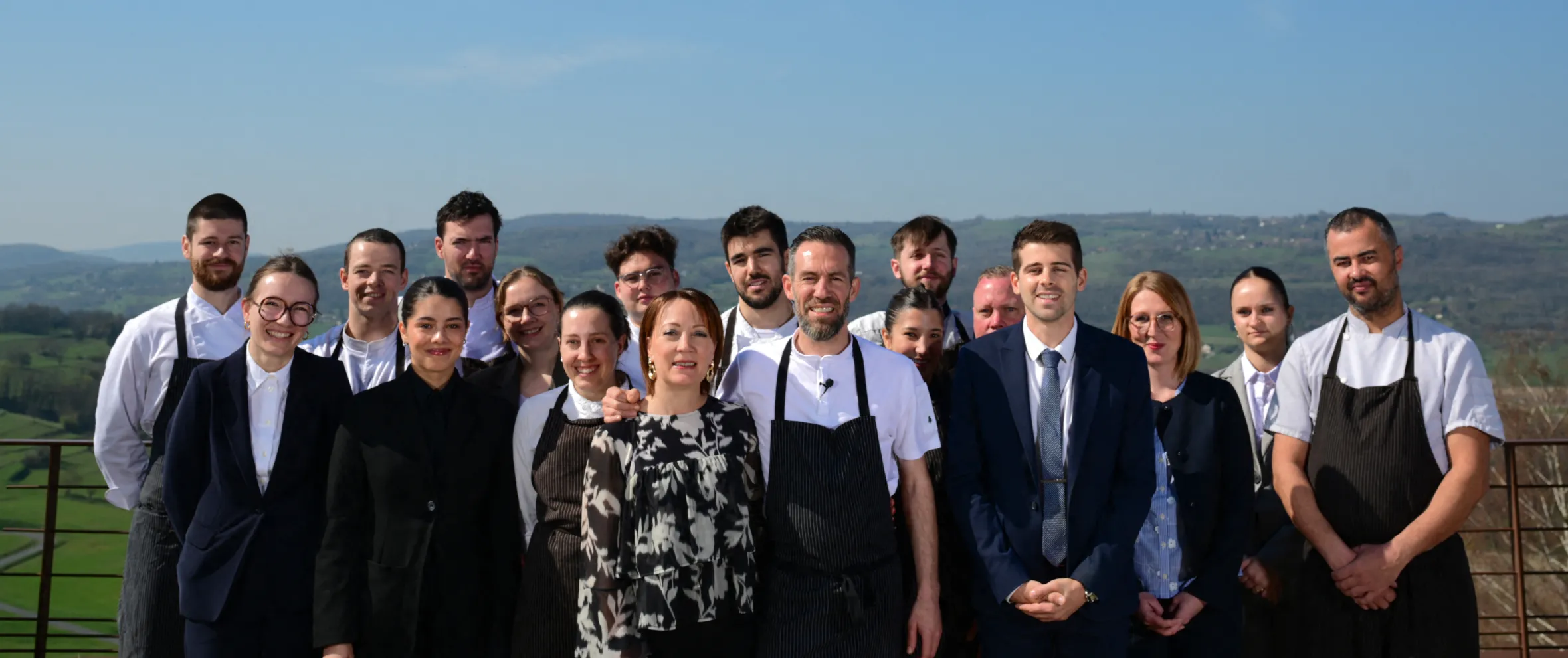 Chef Michael Arnoult, his wife Ingrid, and their restaurant staff pose for a photo.