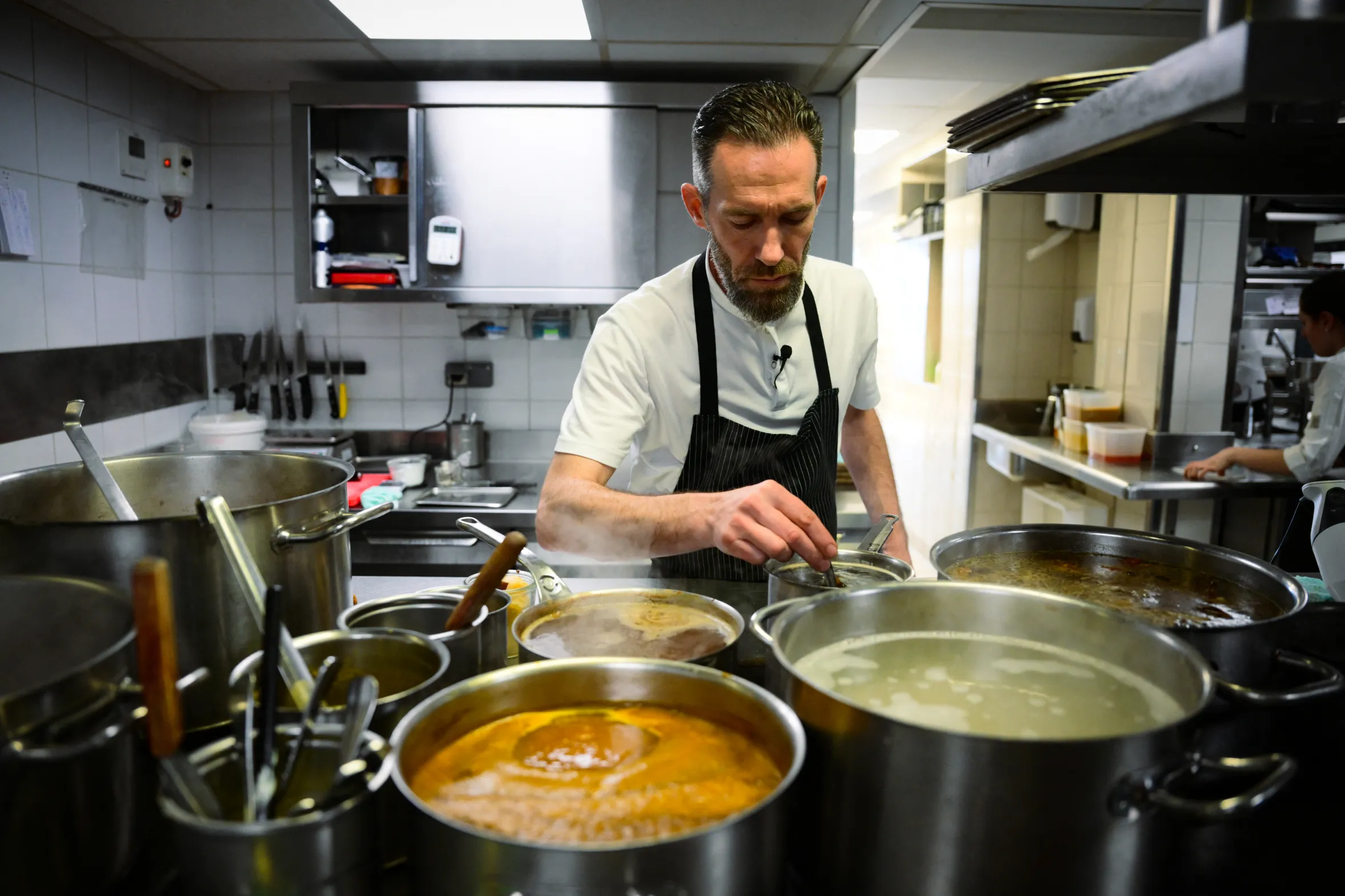 French chef Michael Arnoult cooking in the kitchen of his restaurant Les Morainieres.
