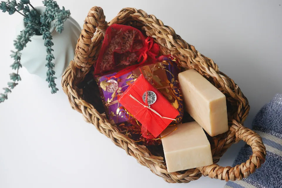 A beautifully arranged gift basket filled with treats and soaps.