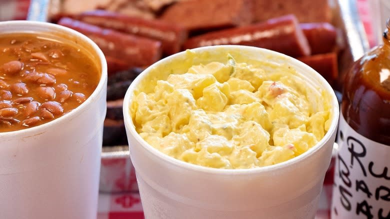 Baked beans and potato salad in takeout containers at Rudy's Country Store and Bar-B-Q
