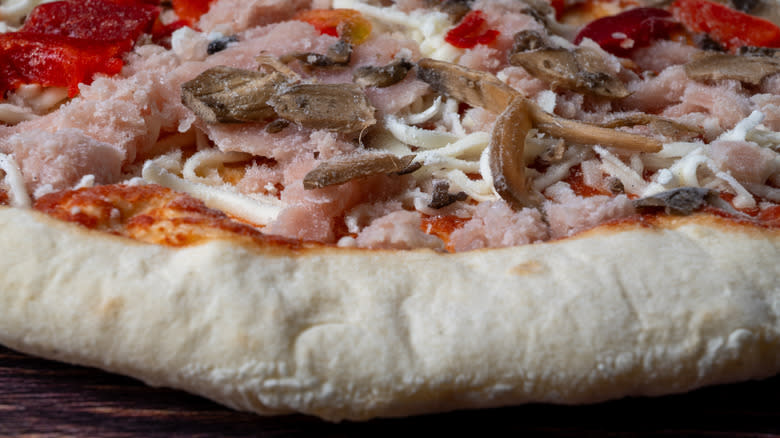 Closeup of a frozen supreme pizza