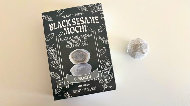 Trader Joe's Black Sesame Mochi piece next to a box on a white table