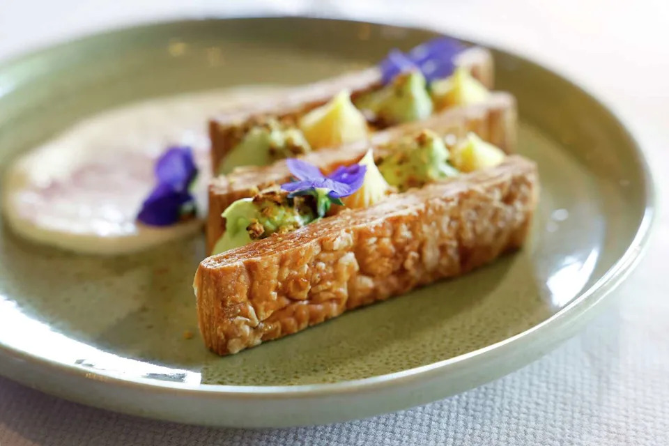 Deconstructed Baklava is made with mille-feuille crust, pistachio crêmeux, lemon curd, honey creme fraiche and a za'atar pistachio crumble at Alara in Dallas. (Tom Fox/The Dallas Morning News)