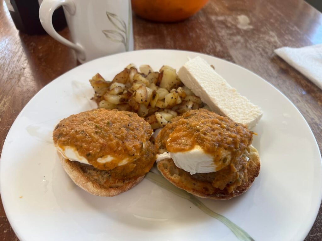 Sausage Eggs Benedict’s with red salsa with fried potatoes and queso fresco