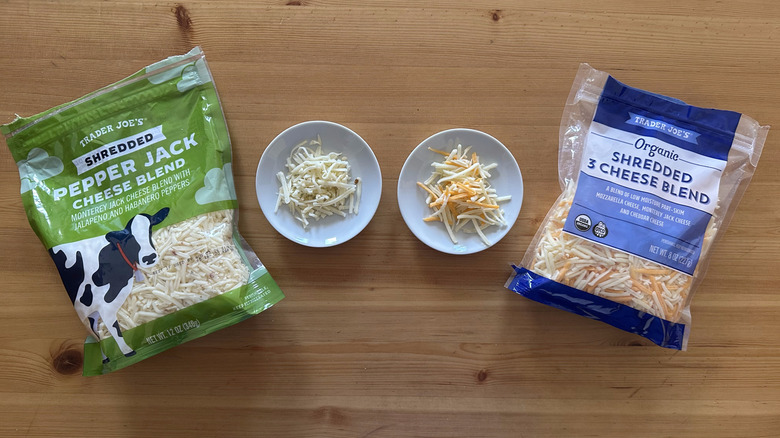 Bags of Trader Joe's cheeses on wooden table