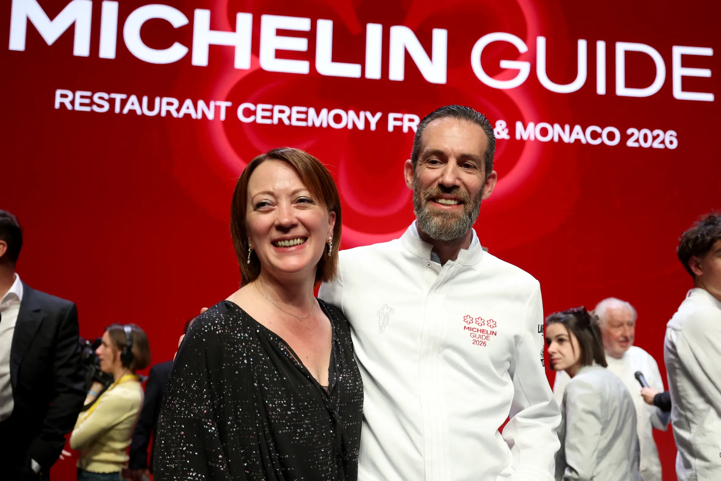 Michael Arnoult and his wife Ingrid smiling at the Michelin Guide award ceremony.