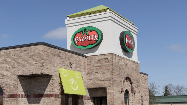 Brick exterior of Fazoli's restaurant showing logo signage with tomato graphic