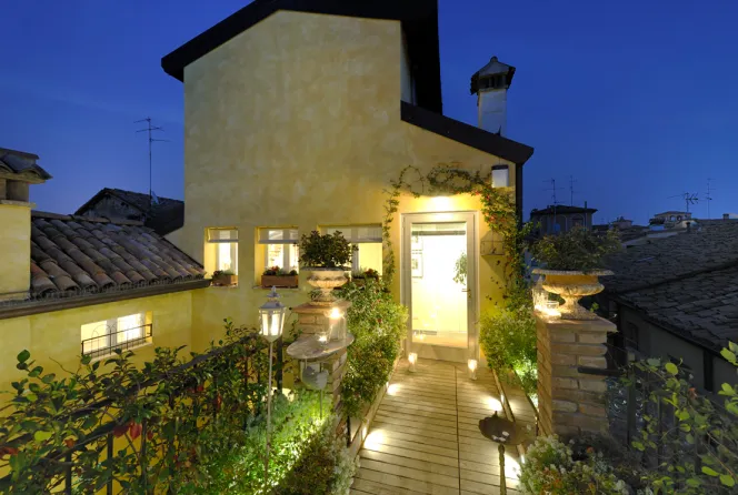 Exterior of Quartopiano Modena at night.