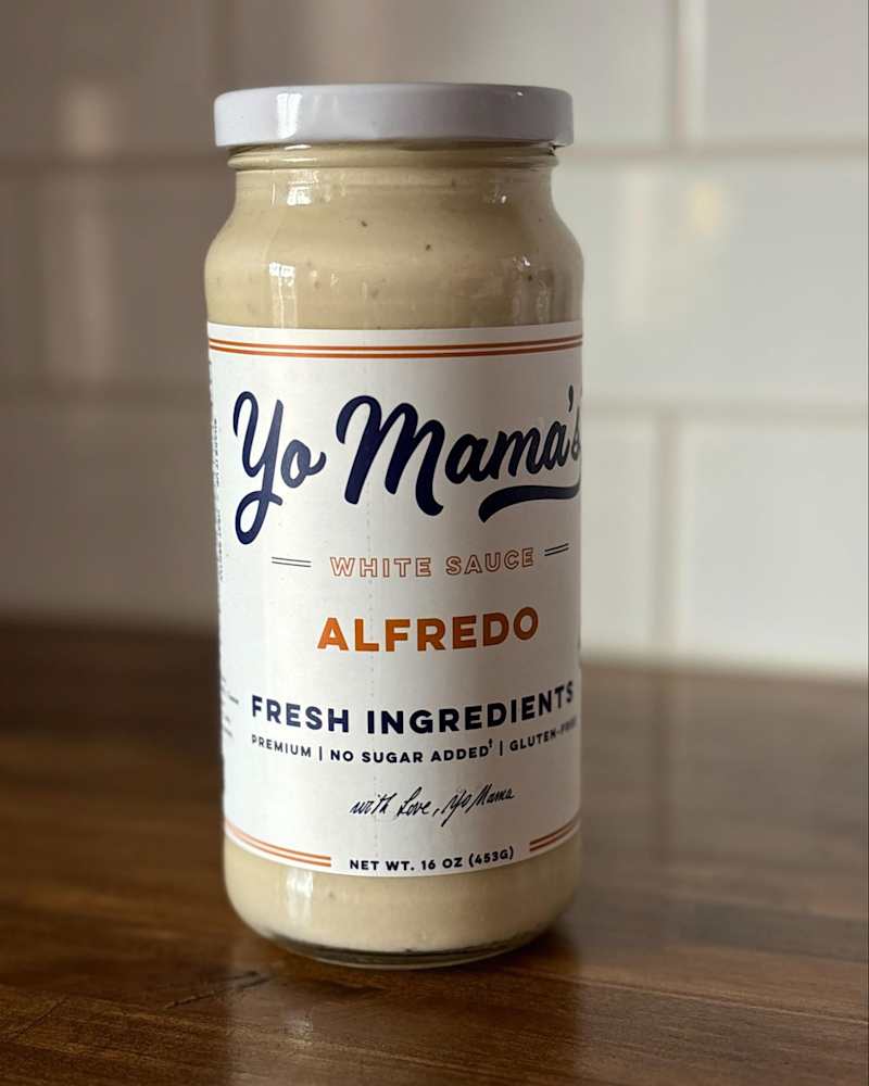 Yo Mama's alfredo sauce on countertop.