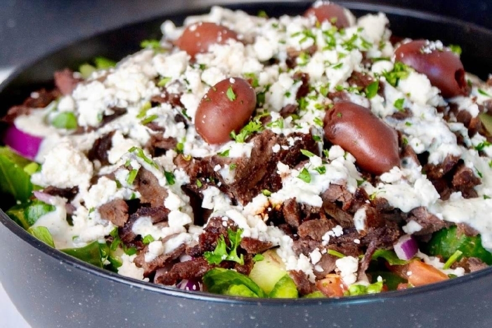 Sheesh Kitchen serves Mediterranean fare in Frisco Overview of a Greek salad featuring olives and white dressing.