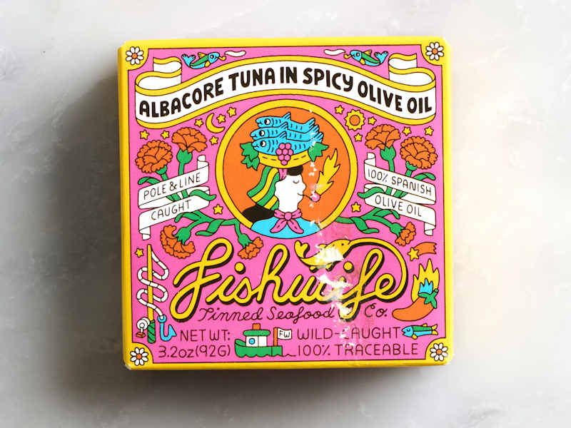 Colorful packaging for albacore tuna in spicy olive oil, featuring floral designs and playful graphics.