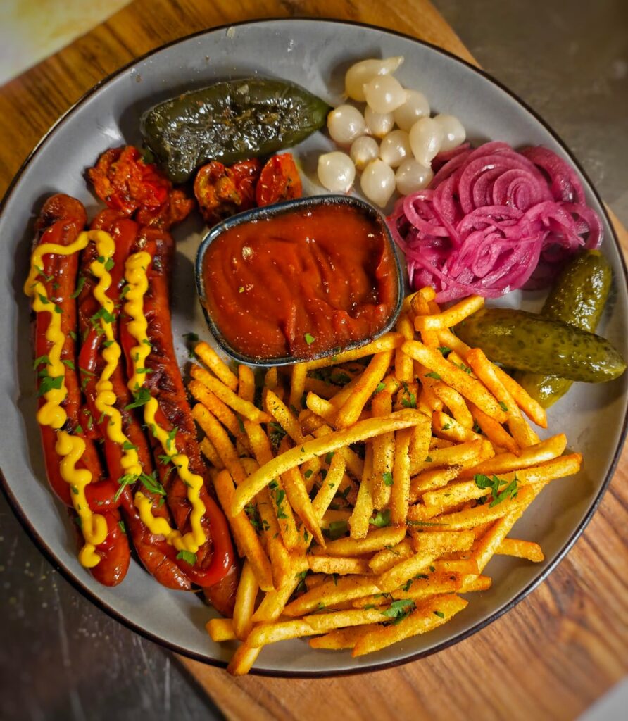 Back with hot dogs again. Sriracha sausages with fries, grilled jalapeño, and all sorts of pickled stuff