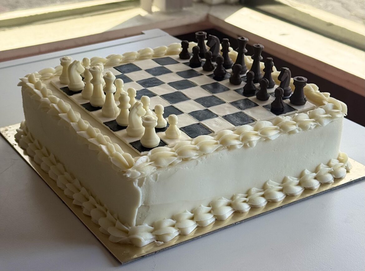 Chessboard cake with chocolate pieces. They actually played a game before eating the pieces they captured!