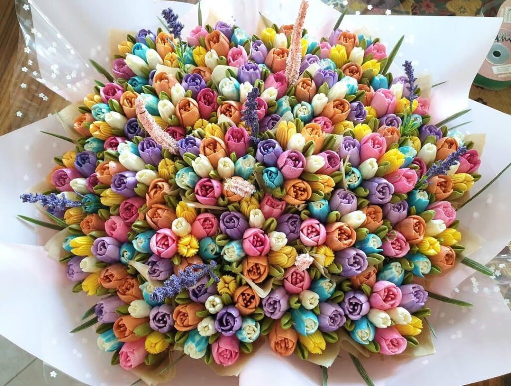 A 19 cupcake bouquet covered in bright tulips. Delicate hands were needed for this one!