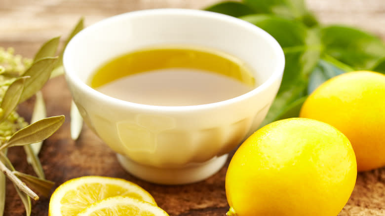 A small bowl of olive oil and lemons