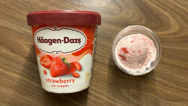 Häagen-Dazs Strawberry Ice Cream carton next to ice cream in glass ramekin