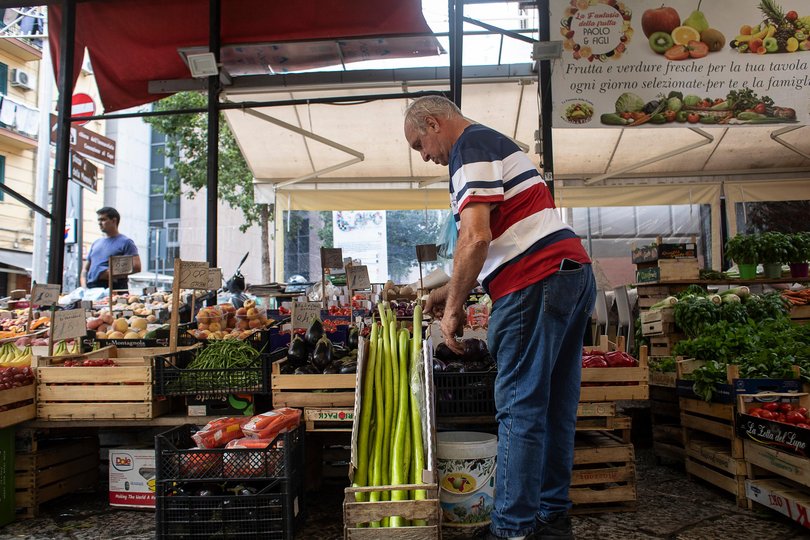 Paolo Di Carlo, a vendor, with cucuzza, a long zucchini native to Sicily, in the Mercato del Capo in Palermo, Italy.