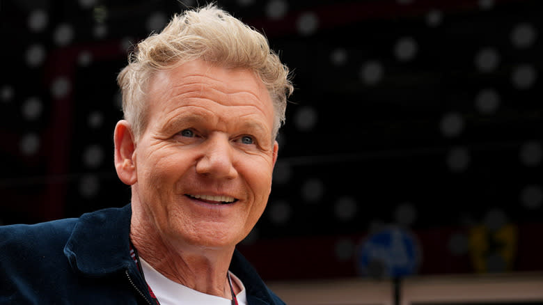 Gordon Ramsay in a jacket, smiling