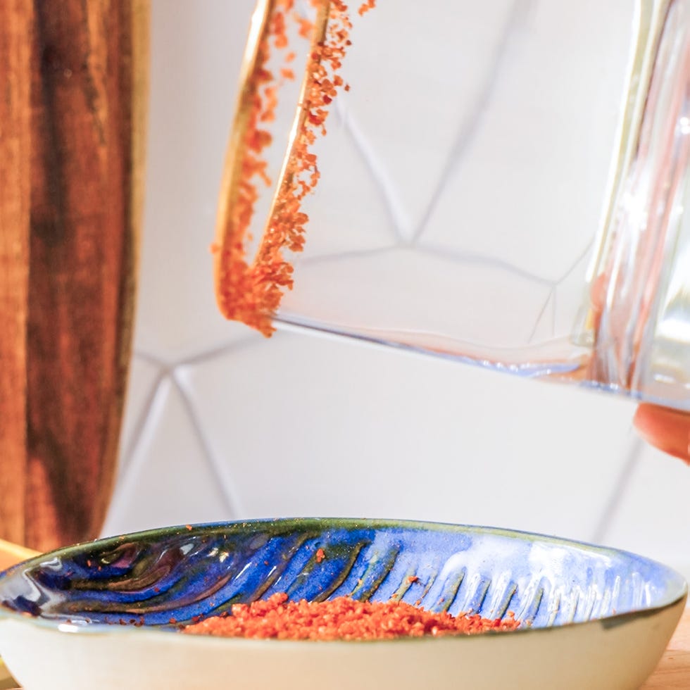coating the rim of a glass with red chile salt.