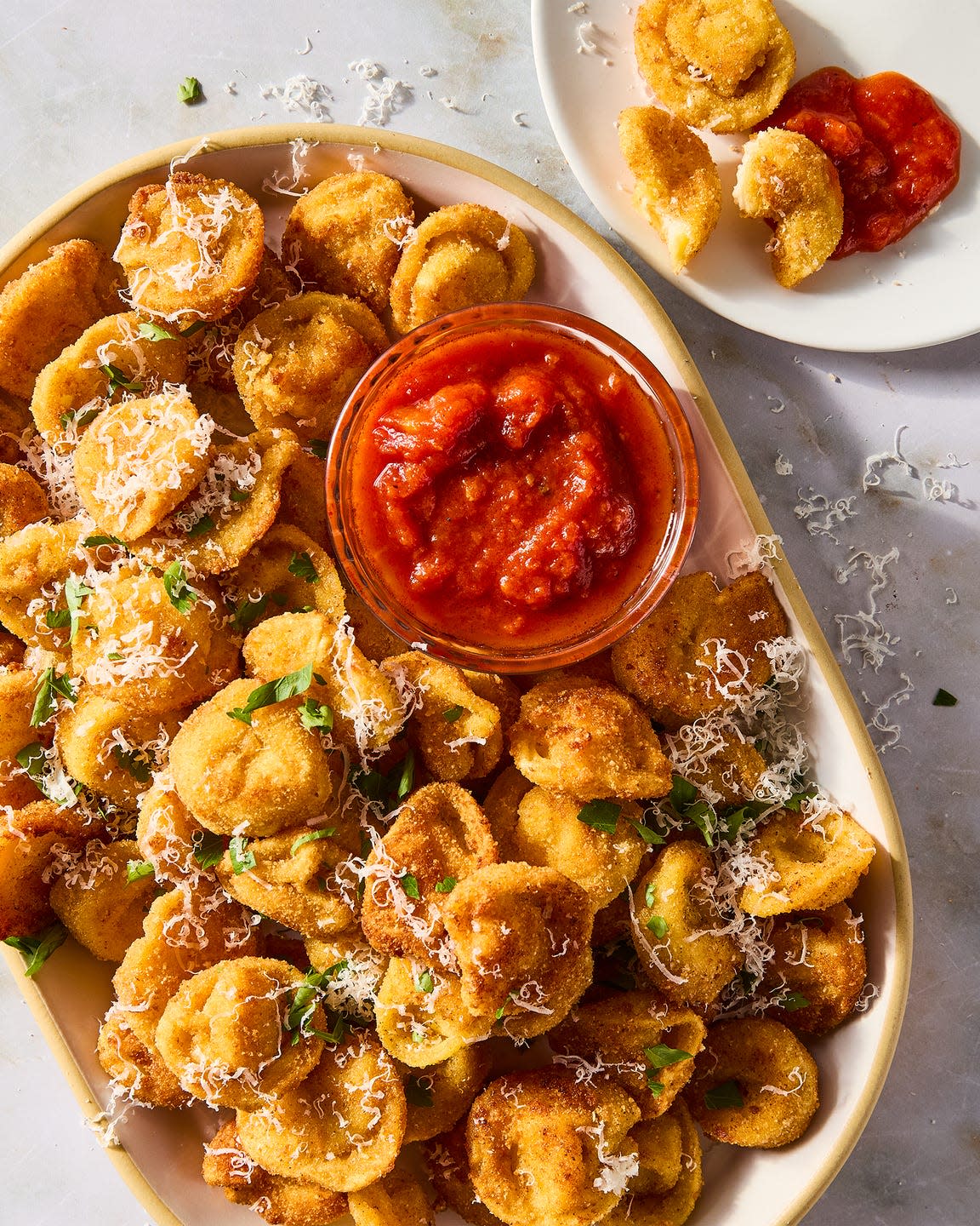fried bites of tortellini topped with parmesan and served with marinara sauce